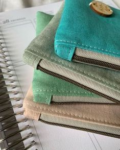 a stack of folded notebooks sitting on top of a table