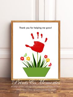 a red handprinted flower pot with flowers in it and the words thank you for helping me grow