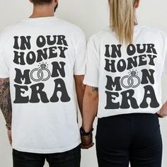 two people wearing matching shirts that say in our honey, man and woman era on them