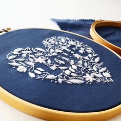 a pair of scissors sitting on top of a table next to a blue cloth covered bag