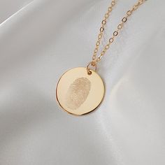 Create your personalised Precious Hearts engraved fingerprint necklace- perfect for a keepsake gift for yourself or a loved one. After placing your order I will design, engrave and polish your bespoke piece. The finished product is a beautifully crafted piece that can withstand wear through showers, exercise and sleep. SIZING 19mm pendant, chain measures 45cm. PROVIDING YOUR FINGERPRINT - After placing your order send a clear photo of your fingerprint via Messages. If you don't have a print ready to go, get in touch and I will send a complimentary Fingerprint Kit. This will delay your order so if your order is time-sensitive you may find it is quicker to obtain the fingerprints yourself using an ink pad, however the Fingerprint Kits use forensic-grade ink resulting in a high-quality print. Finger Print Pendant, Finger Print Necklace, Fingerprint Necklace, Thumb Prints, Fingerprint Jewelry, Finger Print, Pendant Necklace Gold, Printed Jewelry, Mens Pendant