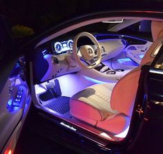 the interior of a car is lit up with blue lights