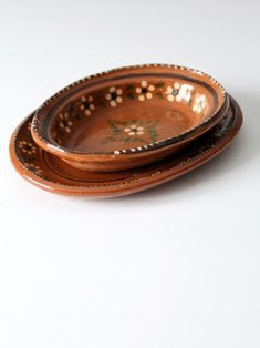 two brown plates sitting on top of each other