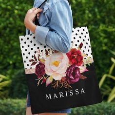 a woman carrying a personalized shopping bag with flowers on the front and back side