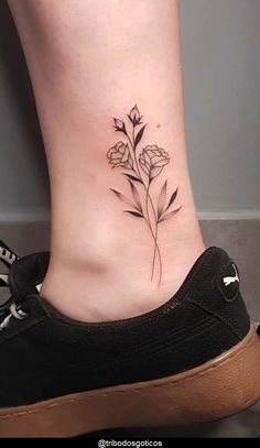 a small flower tattoo on the ankle