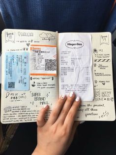 a person is holding a passport and looking at the boarding information on their flight ticket