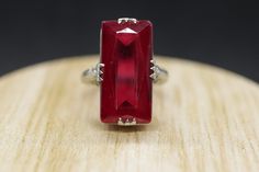 This is a super unique ring. Excellent Pinkie ring. LC ruby glass stone Condition: Shows minimal signs of wear. Has not been polished. Details: 14k White Gold 4.4grams Marked 14k 8mm by 18mm Rectangle LC Ruby glass 6mm rise sz 5.25 Unique Hallmarked Ruby Ring For Formal Occasions, Unique Handmade Formal Ruby Ring, Unique Handmade Ruby Ring For Formal Occasions, Formal Ruby Crystal Ring Fine Jewelry, Handmade Elegant 14k Gold Ruby Ring, Handmade 14k Gold Elegant Ruby Ring, Handmade Elegant Ruby Ring In 14k Gold, Art Deco Ruby Ring For Formal Occasions, Modern Sterling Silver Ruby Wedding Ring