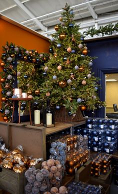 a christmas tree surrounded by boxes and candles