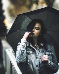 a woman holding an umbrella in the rain