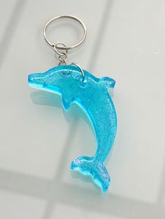 a blue dolphin keychain sitting on top of a table