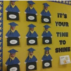 a bulletin board with pictures of graduates in graduation caps and gowns on it's sides