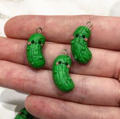 three small green peas sitting on top of each other in the palm of someone's hand