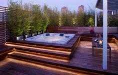 a hot tub sitting on top of a wooden deck