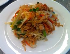 a white plate topped with noodles and vegetables