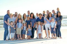 a large group of people standing on top of a beach