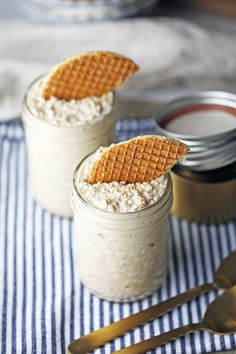 two small jars filled with oatmeal and topped with waffles on top