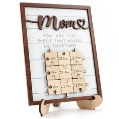 a wooden puzzle with the words mom on it