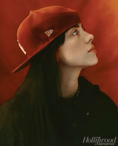 a woman with long hair wearing a red hat