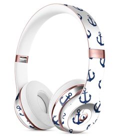 the white and blue anchor headphones are on top of each other, with gold trimming