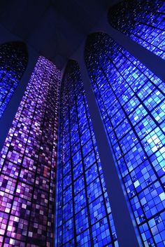 two very tall colorful glass windows in a building