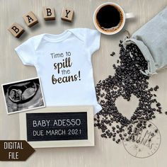 a baby announcement is displayed with coffee, beans and other things to write on it