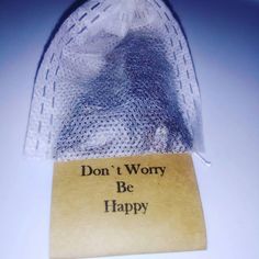 a piece of cloth with the words don't worry be happy written on it