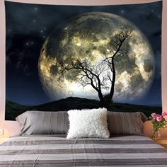 a bed room with a large wall hanging above it and a tree on the side