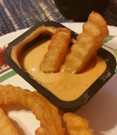 some fried food on a plate with dipping sauce