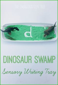 the dinosaur swamp writing tray is made with green paper and some type of animal on it