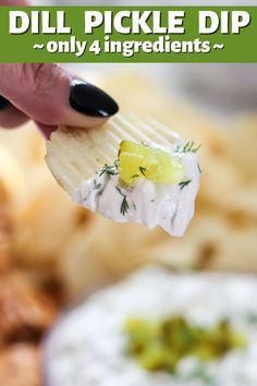 a hand holding a cracker with dip on it in front of some other snacks