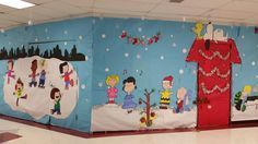 a classroom decorated for christmas with decorations on the walls and in the background, children's artwork