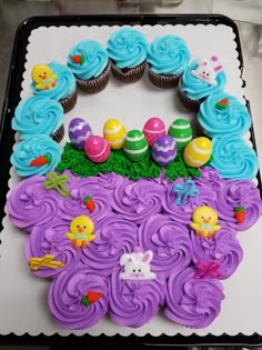 there is a cake decorated with cupcakes in the shape of an easter scene