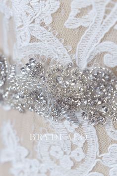 This beautiful stunning ivory satin wedding dress sash is created with sparkling rhinestones and sophisticated beading work. This fine ribbon will add visual interest to a simple bridal gown. content satin, rhinestones, bugles, alloy embellished portion length 45cm, width 4cm ribbon length 275cm, width 2cm Silver Bedazzled Bridal Belt For Wedding, Embellished Silver Bridal Belt, Silver Embellished Bridal Belt, Ivory Satin Wedding Dress, Rhinestone Wedding Dress, Simple Bridal Gowns, Wedding Dress Sash, Dress Sash, Satin Wedding Dress