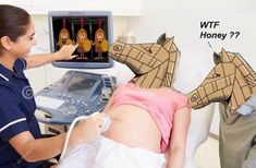 a pregnant woman laying on top of a bed in front of a computer monitor with paper cutouts of horses