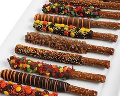 a white plate topped with lots of candy covered pretzels