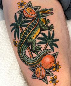 a lizard with oranges and palm trees on it's legs is depicted in this tattoo design