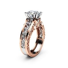 a rose gold engagement ring set with an oval center stone and filigrees