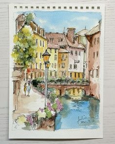 a watercolor painting of some buildings and a river