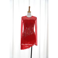 a mannequin wearing a red top with sequins on it