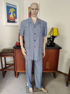 This is another leisure suit that I'm listing and you are in luck if you are looking for a larger size. This one is in a great denim blue colour with navy piping - so smart mde in Singapore in the 70s. The jacket has short sleeves and a four button closure with blue pearly buttons. There is extensive piping accentuating the panels cuffs and pockets. The jacket has a back waist band, back vent and a  pleat centre back, is lined across the it shoulders and  partly in the front . There are large de Leisure Suit, Blue Colour, Waist Band, Denim Blue, Sport Coat, Mens Suits, Blazer Suit, Piping, Blue Denim