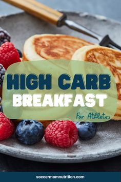 high carb breakfast for athletes on a plate with berries, pancakes and raspberries