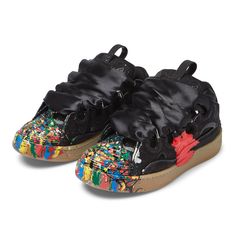 a pair of black shoes with colorful paint on them