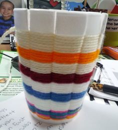 there is a knitted cup sitting on the table