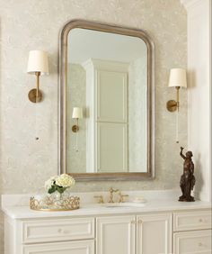 a bathroom vanity with a large mirror above it