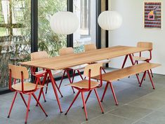 a dining table with four chairs and a bench in front of a glass door that leads to an outside patio