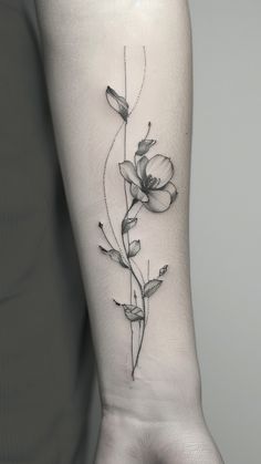 a black and white photo of a flower on the left arm, with leaves growing out of it