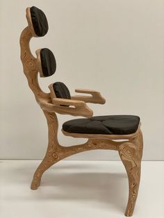 a chair made out of wood and black leather