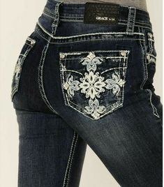 The Grace in LA women's bootcut jean in Easy Fit shows off your best shape by featuring a higher rise. The denim fabric features a softer and higher stretch for exceptional comfort all while maintaining a denim look. The mid-rise creates a form-flattering fit for every curve. The jean is detailed in a cross embroidered design on the back pockets, added embellishment on the front pockets, natural hand-sanding, and whiskering. They look like they've been yours forever. Grace in LA women's bootcut Jeans Mexican, Fitted Jeans With Pockets For Rodeo, Bedazzled Jean Pockets, 2000s Aesthetic Grunge, Bling Pocket Jeans, Grace In La Jeans, Bootcut Rhinestone Jeans, Bootcut Jeans With Pocket Design, La Girls