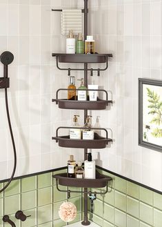 a bathroom with a shower head, shelves and toiletries on the wall next to it