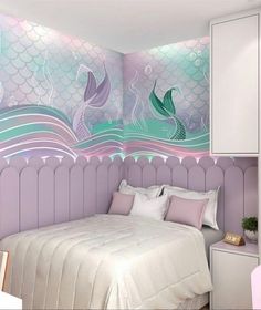 a bedroom decorated in pastel colors with mermaid tails on the wall